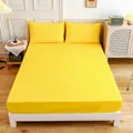 Modern lemon yellow fitted sheet and pillowcase set in a minimalist bedroom setting - Lemon Yellow