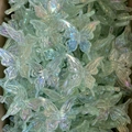 Macro shot of iridescent baroque butterfly charms for DIY phone chains and hair accessories - Green