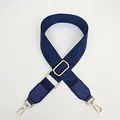 Close-up of dark blue canvas strap featuring adjustable golden metal hooks and texture - Blue / Silver
