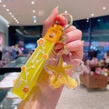 Llavero de arena movediza estrella con estrella de mar amarilla y correa de mano de silicona - Amarillo