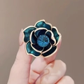 Close-up of blue camellia flower brooch with gold edges and centered blue crystal jewel - Rhinestone Flower Style (X0187)