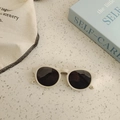 Lunettes de soleil bébé en silicone beige avec verres foncés sur plan terrazzo - Blanc Cassé