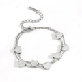 Detail view of double-layer stainless steel bracelet with five heart pendants and lobster clasp - Steel