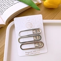 Detailed view of three silver metallic Y2K hollow hair clips on a white display card - Hollow Oval Style / Set of 3
