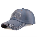 Detailed close-up of crown rhinestone patterns on blue denim baseball cap for women - Blue Denim Texture