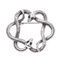 Detailed view of intertwined vintage snakes brooch with silver scales and green zircon eyes - Double Snake Silver