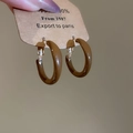 Detailed macro shot of caramel brown enamel hoop earrings with gold metal clasp detail - Medium Smooth Round (Silver Needle) / Caramel Brown Smooth