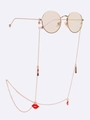 Golden eyewear chain with red lip pendants and heart charms on white background - Gold Red Lips Lipstick