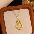 Macro shot of gold stainless steel necklace with textured hexagonal geometric pendant - Gold Hexagonal Geometric Texture Necklace