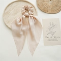Champagne satin scrunchie with long ribbons on stone tray for elegant ponytail styling - Khaki