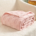 Pink checkered embossed thick fleece blanket neatly folded on soft white texture - Pink