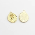 Detailed view of oval enamel rose pendants with textured golden metal backing for DIY jewelry - Yellow