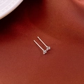 Macro shot of silver zircon stud earrings on red-brown fabric showing detailed prong setting - 3mm Zircon (925 Silver Pin)