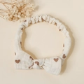 Detailed texture of baby cotton bow headband with brown heart prints on cream fabric - Brown Heart
