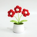 Detailed view of hand-knitted potted plant with red flowers and white ceramic base - Puff Flower Red