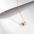 Detail of rose gold bee pendant with black oil dripping and sparkling zircon stones - 925 Silver / Rose Gold