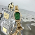 Detailed side view of tonneau gold quartz watch with emerald dial and diamond bezel - Gold Color Green