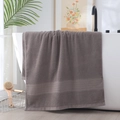 Thick dark grey cotton bath towel with textured weave draped over a white bathtub - Herringbone Border Hand Towel (Dark Grey) / 34*74cm
