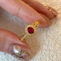 Vintage style gold ring featuring an oval red stone with a halo of clear diamonds - Gold Oval Red Main Stone Halo Design Ring (J5763)