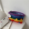 Close-up of rainbow knit bag showing colorful pom-poms, white clouds, and plaid lining detail - Coin Purse