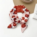 Pink silk scarf with red floral prints tied in a bow on a stylish lifestyle background - Red Floral