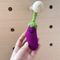 Handmade wool felt eggplant keychain in purple and green colors with a cute smile - Eggplant