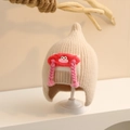 Detail of baby winter knit hat featuring cute cartoon eyes and pink braided tassels - One Size (Toddler) / Beige
