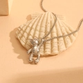 Polished silver bear pendant necklace on thin O-chain with elegant shell backdrop - Steel Color (E116)