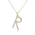 Macro shot of 18K gold plated necklace featuring letter R pendant with cubic zirconia - Letter R
