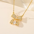 Macro detail of gold bow necklace with white cubic zirconia pavé and center round gem - White Rhinestone Bowknot (F411)