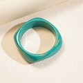 Detailed macro view of the turquoise marble pattern on a square resin bangle - Blue