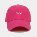 Close-up of white 'hey!' embroidery on a fuchsia cotton baseball cap detail - Adjustable / Rose Red
