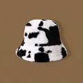 Plush faux fur bucket hat with black and white cow print for winter warmth - Cow Print Bucket Hat - Black