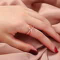 Rose gold adjustable ring with crisscross pave zircon on pink silk background - SE796 Rose