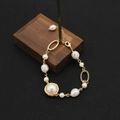 Handmade gold pearl bracelet featuring a unique wire-wrapped baroque pearl charm - Irregular Metal Bracelet