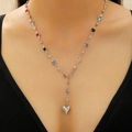 Silver Y-necklace with multi-color zircon stones and a 3D heart pendant worn by a model - Silver Steel Heart Y-shaped (1969)
