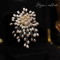 Macro shot of luxury pearl snowflake brooch with gold wire weaving on black box - Elegant Pearl Style SG-2