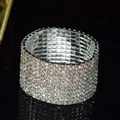 Macro shot of wide multi-row sparkling rhinestone bridal bracelet on reflective surface - 10 Row Silver Clear Rhinestone Bracelet