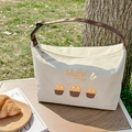 Isolierte Segeltuch-Lunchtasche mit Muffin-Cartoon und braunen Tragegriffen - Muffin