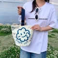 Off-white canvas bucket bag with blue cloud face print and navy blue handles - Sunflower