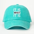 Front view of turquoise washed baseball cap featuring the slogan IT IS WHAT IT IS - One Size(Adjustable) / Washed Lake Blue