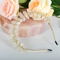 Close-up of golden headband with raw quartz crystals on pink quartz plate with roses - White Crystal