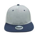 Detail of a snapback cap with grey crown, dark blue brim and silver foil label - Grey with Navy Brim
