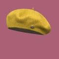 Detailed texture of bright yellow wool beret with small metallic decorative buckle detail - M / Yellow