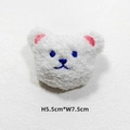Close-up of white plush bear head accessory with blue embroidery, size 5.5cm x 7.5cm - White Bear