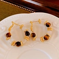 Detailed shot of gold hoop earrings with tiger eye beads and twisted metal spacers - Tiger's Eye & Cat's Eye Gold Hoops (Silver Needle)