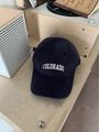 Close-up of navy corduroy baseball cap with Colorado embroidery on a wooden shelf - One Size / Navy Blue