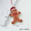 Wooden gingerbread man Christmas ornament with red hat and dimensions of 10cm by 7cm - Gingerbread Man Ornament B