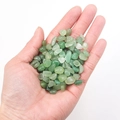Polished green aventurine crystal chips held in hand for cleansing and healing - Green Aventurine (1kg)