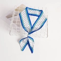 Polka dot twilly silk scarf with blue and yellow borders tied on a white basket - Blue Yellow Polka Dot